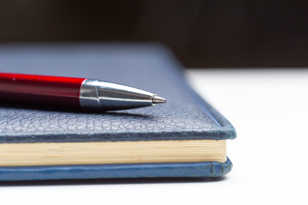Pen and notebook close up